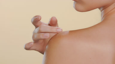 Young beauty model strokes nape, shoulder, soft skin shown