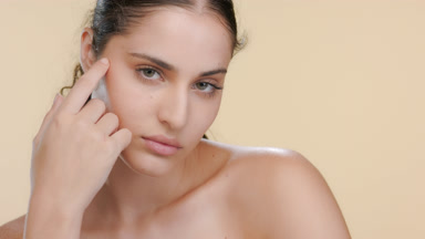 Young Latina with fair skin touches forearm, shows balanced skin