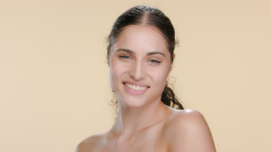 Stylish young Hispanic woman tilts shoulders, smiling