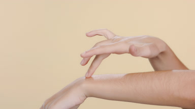 Fair-skinned female massaging hands, moisturized hands