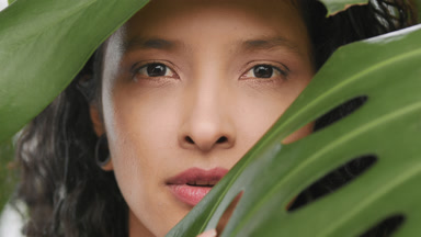 Beautiful woman opens her eyes and looks at the camera