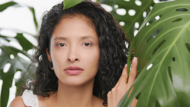 Beautiful young woman looks at camera