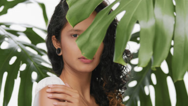 Beautiful argentinean woman strokes her shoulder green location