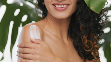 Argentinean model applies lotion on her shoulder